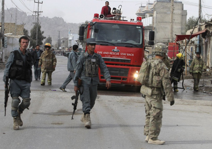 Afghan police officers and foreign soldiers arrive at the site of a suicide attack in Kandahar province in Januray 2012.