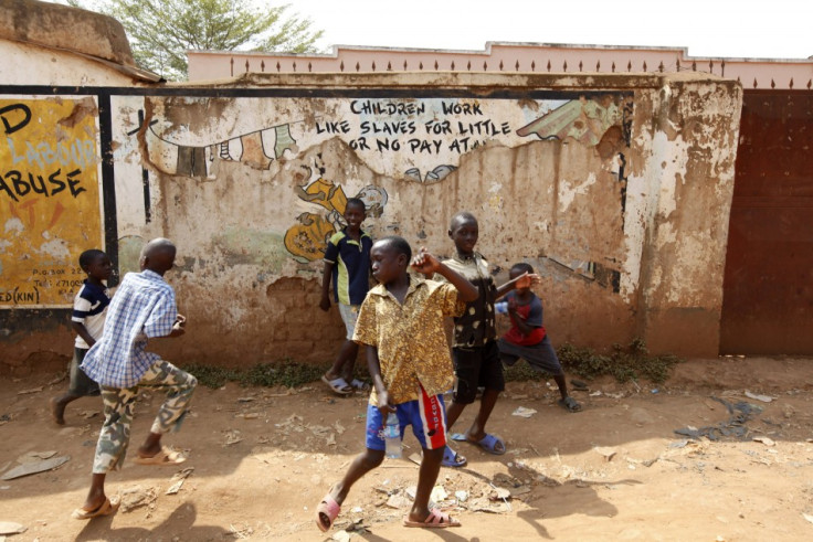 Children play in the street in Kisenyi, a slum in Kampala