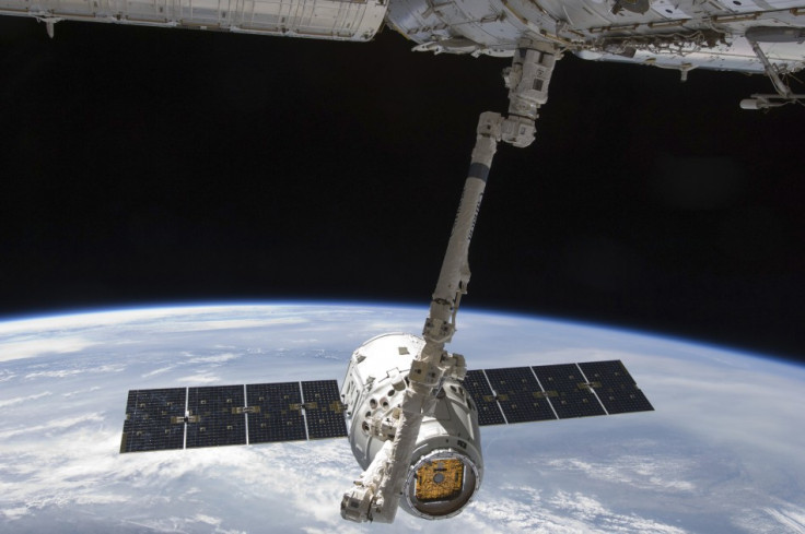 The SpaceX Dragon commercial cargo craft is seen as it is grappled by the International Space Station's Canadarm2 (Reuters/Nasa)