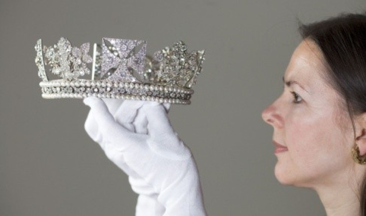 Exhibition Curator Caroline de Guitaut holds Diamond Diadem. (Photo: The Royal Collection)