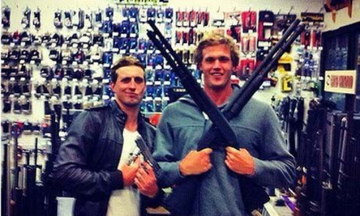 Australian Olympic swimmers Nick D'Arcy and Kenrick Monk posing with guns (Facebook)