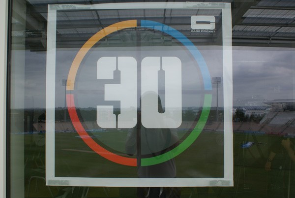 Cage cricket players attempt to bat ball into coloured zones marked on enclosed area