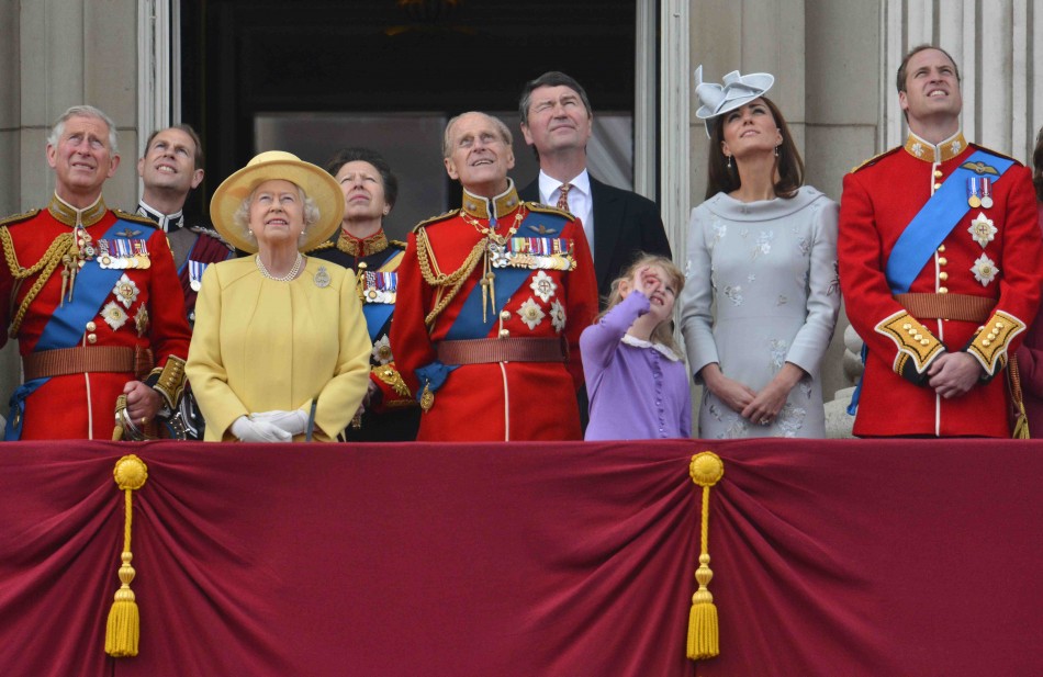 Members of Britain039s Royal family watch a flypast by the Red Arrows as they stand on the balcony of Buckingham Palace following the Trooping the Colour ceremony in central London