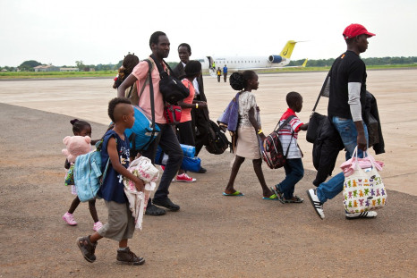 South Sudanese nationals who arrived from Israel walk from their plane at the airport in Juba, Reuters