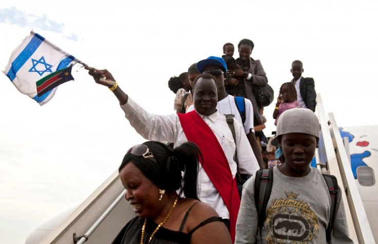 South Sudanese disembark from a plane from Israel that arrived at the airport in Juba, Reuters