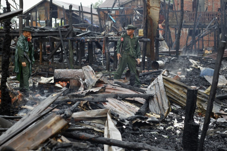 Soldiers patrolneighbourhood burned in recent violence in Sittwe