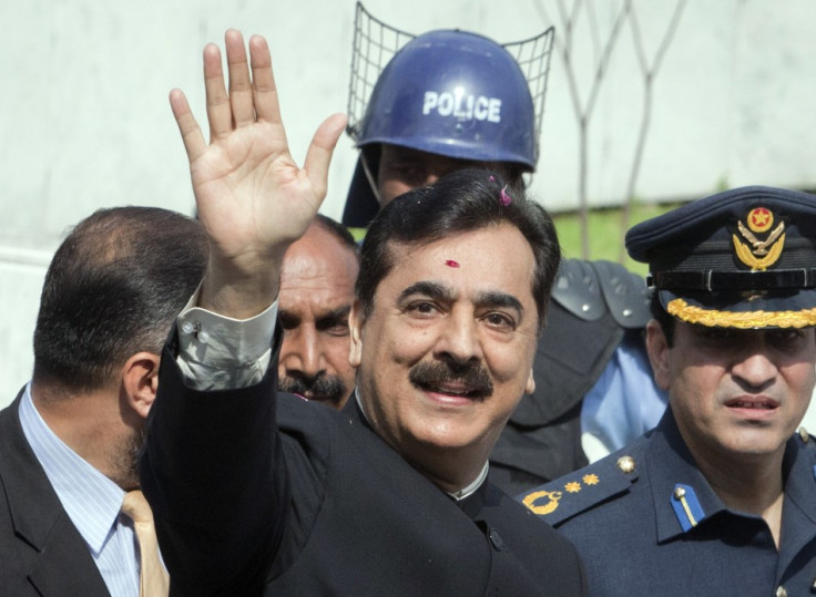 Pakistan's Prime Minister Yusuf Raza Gilani waves after arriving at the Supreme Court in Islamabad