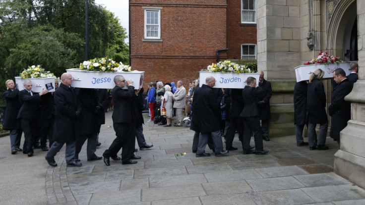 The coffins of six children who died in a house fire are carried into St Mary's Church for their funeral service in Derby (Reuters)