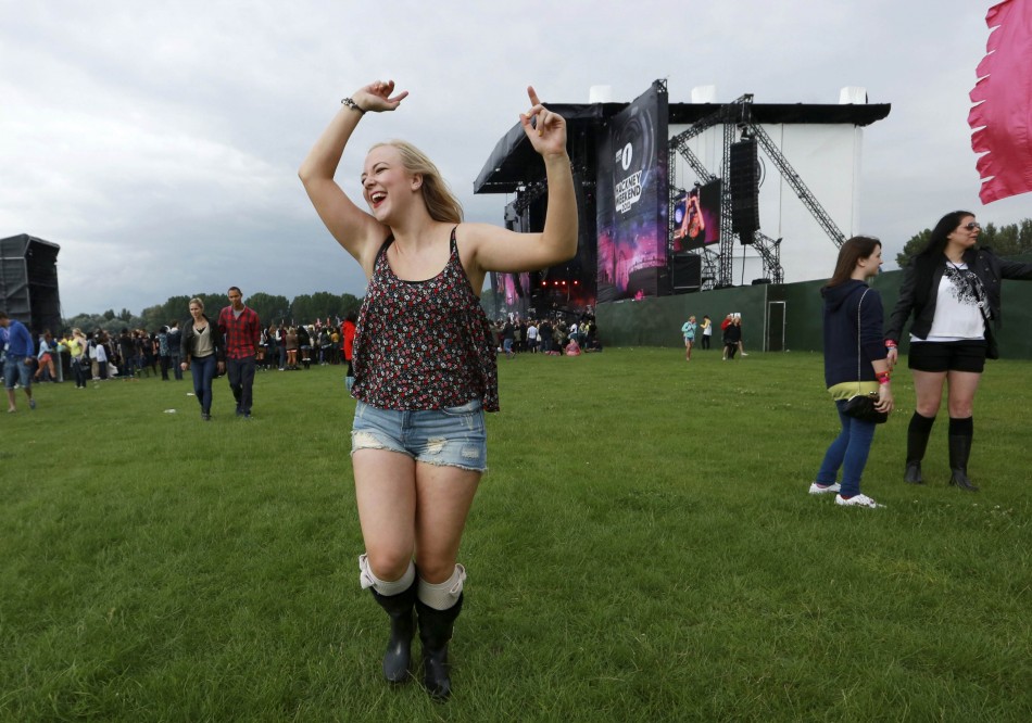 A woman dances near the main stage at the Hackney Weekender festival at Hackney Marshes in east London