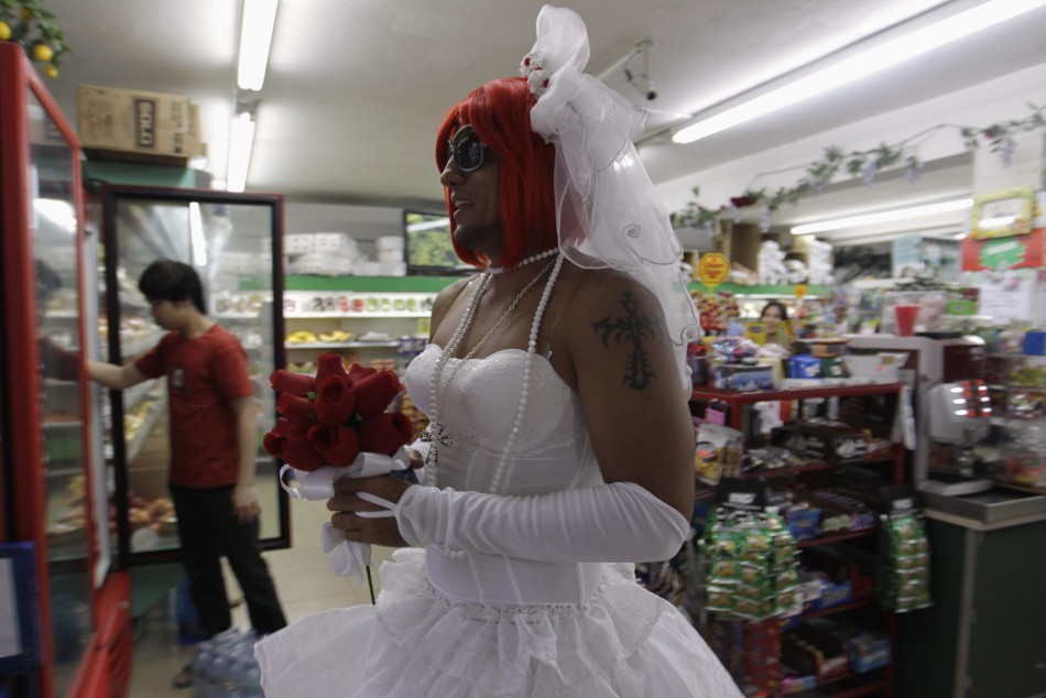 A reveller dressed in a bride costume is seen in a shop during the Gay Pride parade in Panama City