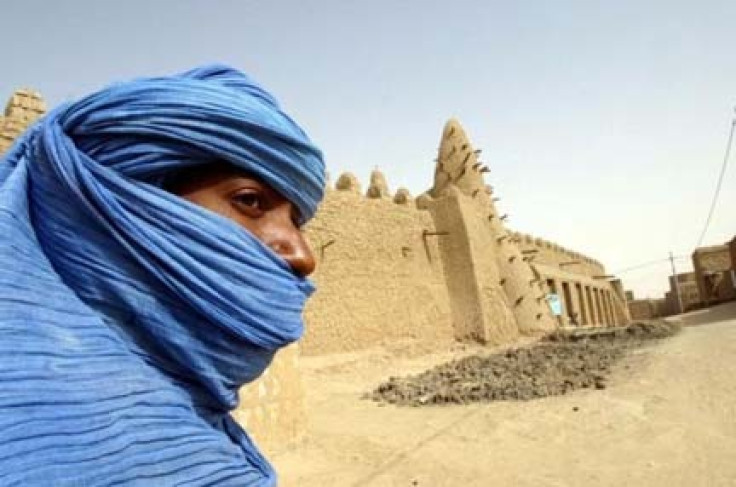 A Tuareg nomad stands near a 13th century mosque in Timbuktu in this file photo , Reuters