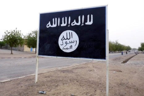 The black flag of the Ansar Dine Islamic group is posted on a road sign in Kidal in northeastern Mali