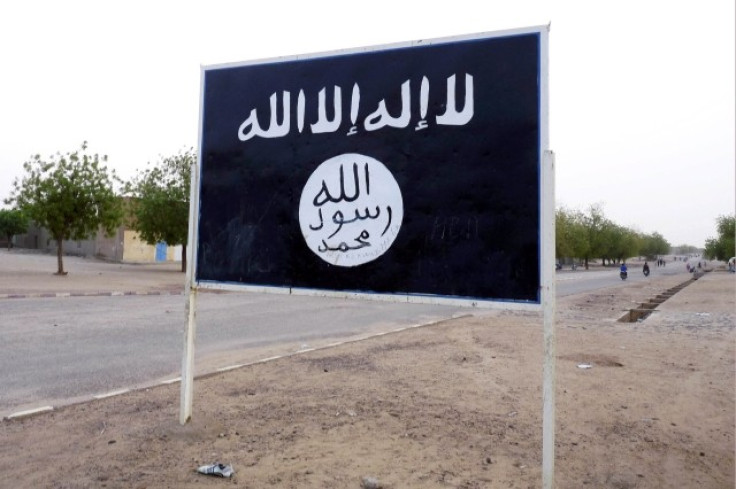 The black flag of the Ansar Dine Islamic group is posted on a road sign in Kidal in northeastern Mali