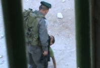 Israeli border police officer kicks Palestinian child Abd a-Rahman Burqan