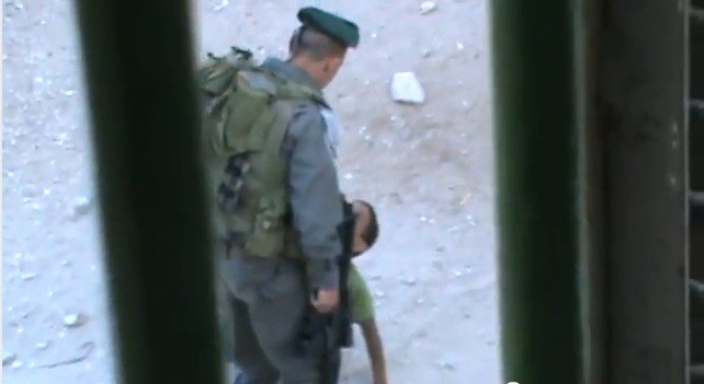 Israeli border police officer kicks Palestinian child Abd a-Rahman Burqan