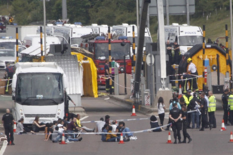 Armed police and Megabus passengers block off the M6 Toll road in Staffordshire after the onboard security scare
