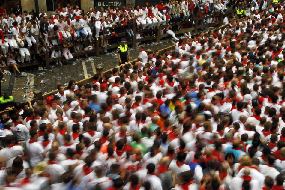 A crowd of runners wait for the start of the first running of the bulls of the San Fermin festival in Pamplona