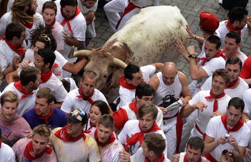Runners dodge a bull during the San Fermin festival in Pamplona