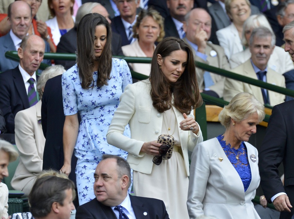 Britains Catherine, Duchess of Cambridge arrives with her sister Pippa Middleton on Centre Court at the Wimbledon Tennis Championships in London