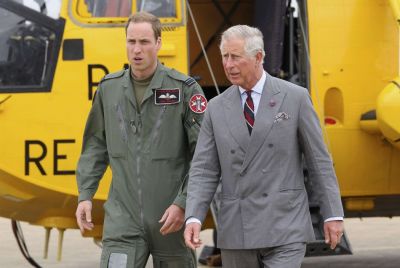 Britain's Prince Charles and his son Prince William walk back to the RAF Rescue base after Prince William showed his father his helicopter at RAF Valley, in Valley, Wales