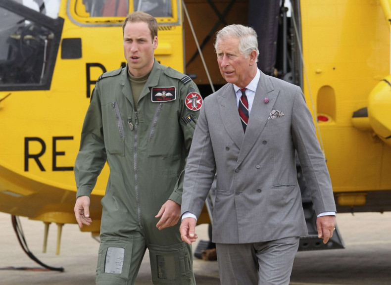 Britain&#039;s Prince Charles and his son Prince William walk back to the RAF Rescue base after Prince William showed his father his helicopter at RAF Valley, in Valley, Wales