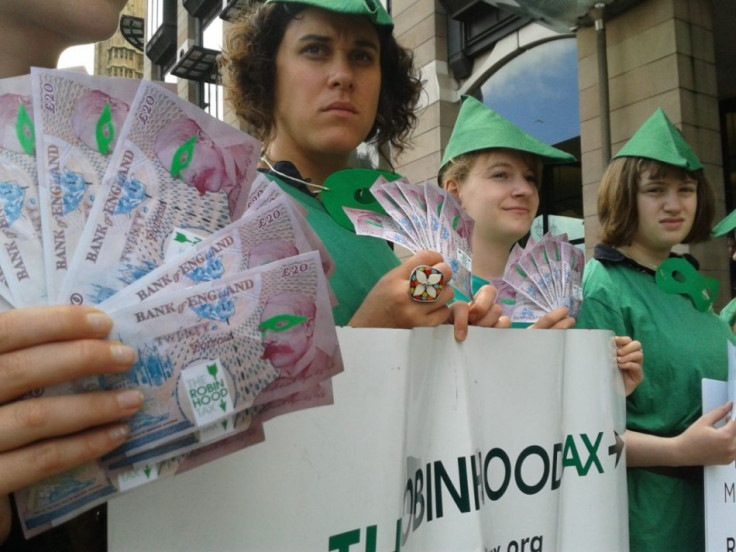 Top: &quot;Robin Hood&quot;-customed demonstrators, demanding a tax on financial institutions, give fake banknotes and coins to consumers at a Barclays bank in London.