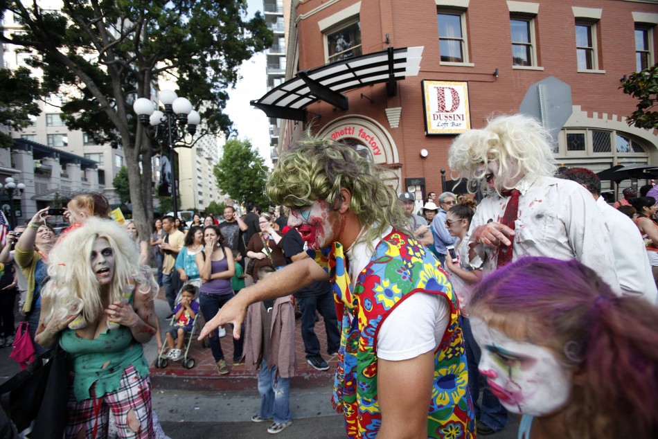 People dressed up as zombies take part in a zombie walk during the Comic Con International convention in San Diego
