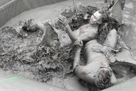 People play in the mud during the Boryeong Mud Festival at Daecheon beach in Boryeong