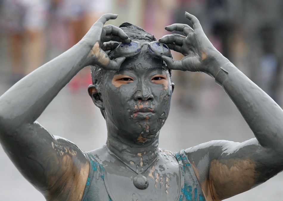 A woman takes off her goggles at the Boryeong Mud Festival on Daecheon beach in Boryeong