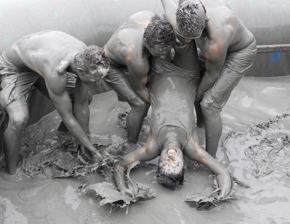 People play in the mud during the Boryeong Mud Festival at Daecheon beach in Boryeong