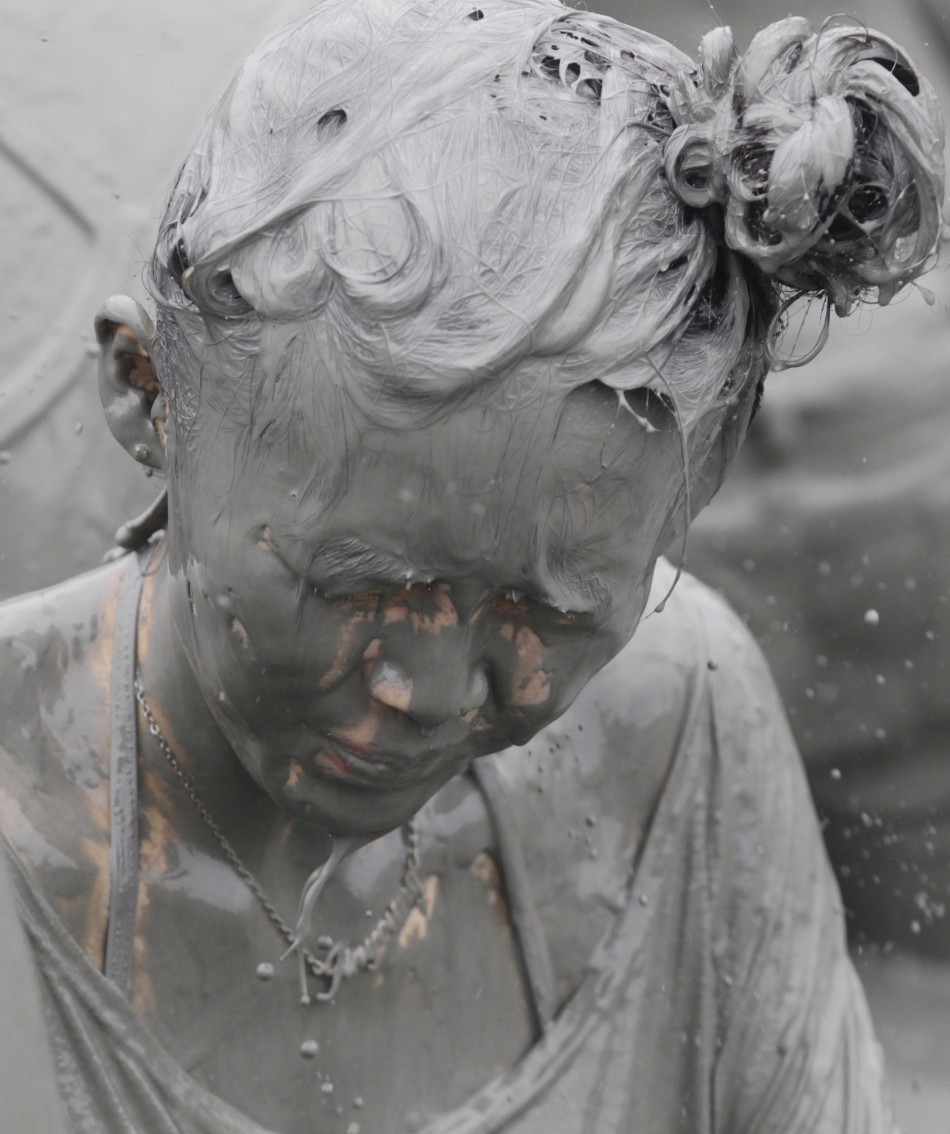 A woman plays in mud during the Boryeong Mud Festival at Daecheon beach in Boryeong