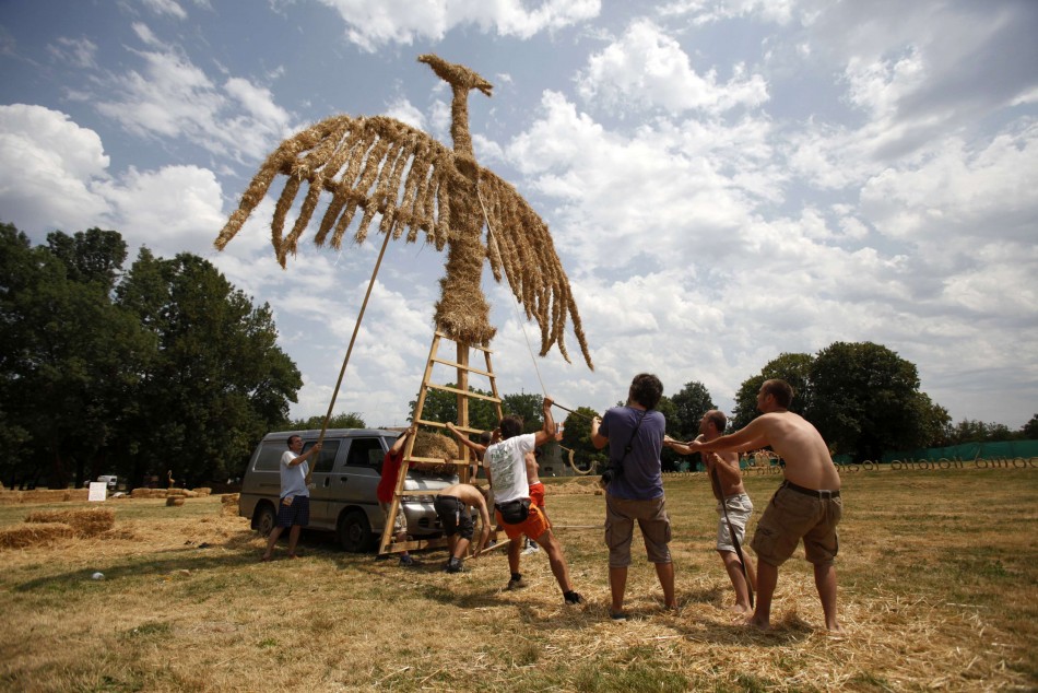Artists set up a 10 meter high straw art installation of a phoenix during the 7th Straw - Land Art Festival in Osijek