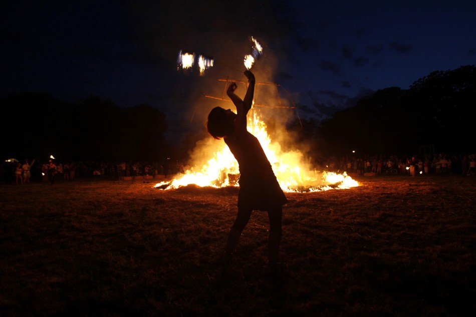 An artist plays with fire during the 7th Straw - Land Art Festival in Osijek