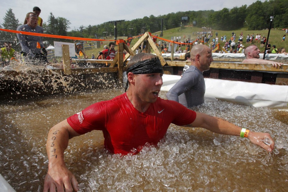 Competitors jump into a vat of ice water during the Tough Mudder at Mt. Snow in West Dover