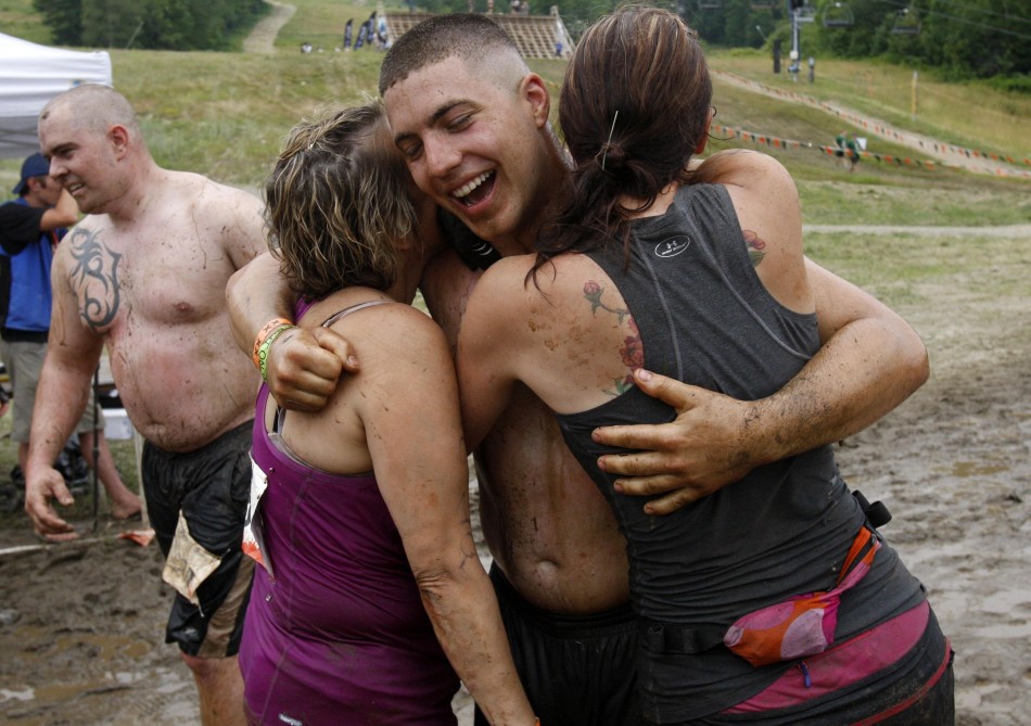 Competitors embrace after crossing the finish line in the Tough Mudder at Mt. Snow in West Dover