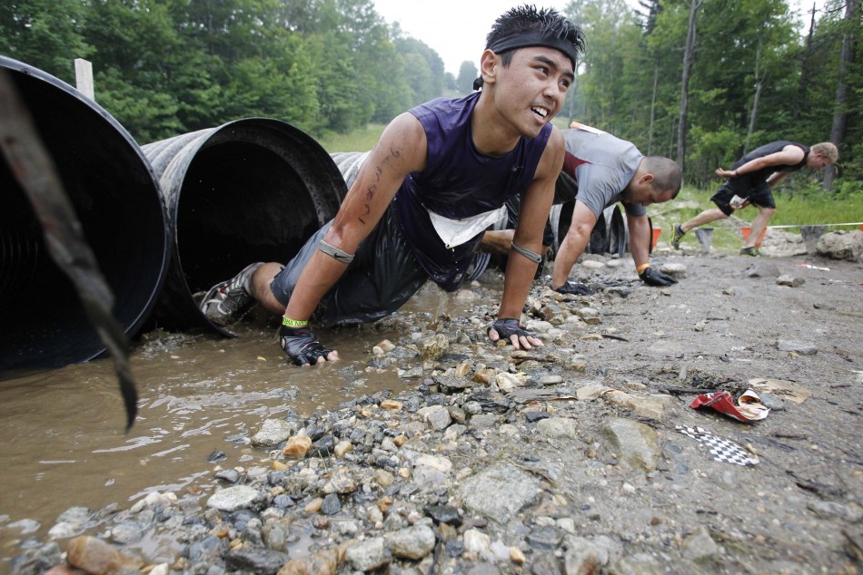 A competitor climbs out of a tube during the Tough Mudder at Mt. Snow in West Dover