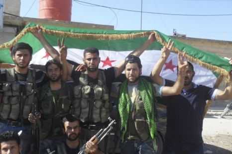 Members of the Free Syrian Army celebrate as the rebels take control of key crossings into Turkey and Iraq.