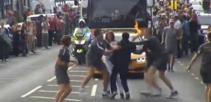 Officers tackle teenager as he tries to grab the Olympic torch in Gravesend (BBC)