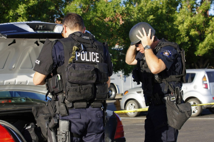 Bomb squad officers outside James Holmes's apartment block in Aurora