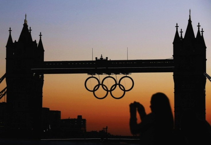A woman photographs the Olympic rings positioned on Tower Bridge for the 2012 London Olympic Games
