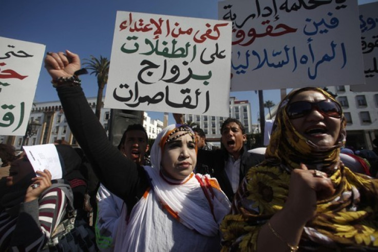 File photo of Moroccans attending a women&#039;s rights rally while holding placards reading &quot;Stop abusing girls&quot; in Rabat February 20, 2012.
