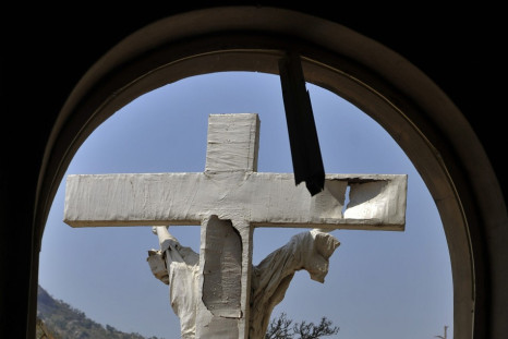 A damaged crucifix overlooks the scene of a bomb explosion at St. Theresa Catholic Church at Madalla, Suleja, just outside Nigeria's capital Abuja, December 25, 2011