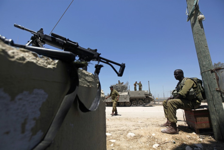 Israeli soldiers guard the border with Egypt at the Kerem Shalom crossing, Reuters