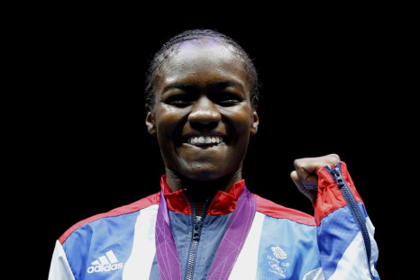 Britain's Nicola Adams poses with her gold medal after defeating China's Ren Cancan during their Women's Fly (51kg) gold medal boxing match at the London Olympic Games