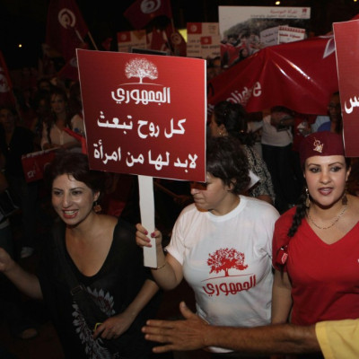 Women carry banners and shout slogans during a demonstration in Tunis, Reuters