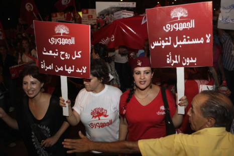 Women carry banners and shout slogans during a demonstration in Tunis, Reuters