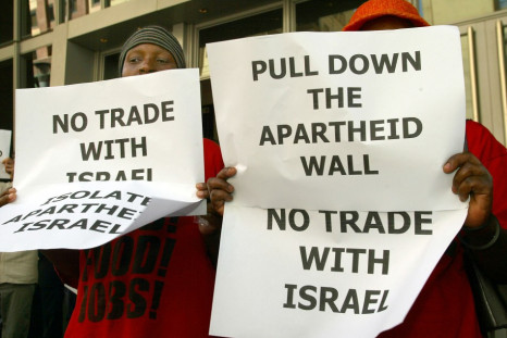 Muslims in South Africa hold posters outside Sandton Convention Centre.