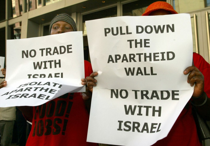 Muslims in South Africa hold posters outside Sandton Convention Centre.