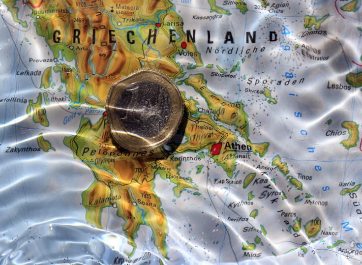 One Euro coin is displayed in water over map showing Greece in this picture illustration taken in Munich