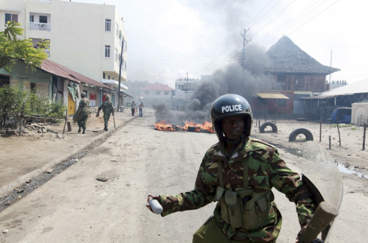 A policeman prepares to lobe a tear-gas canister in the direction of protesting youths in the coastal town of Mombasa